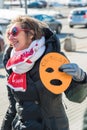 Activist holds the mask, the symbol of Riot on picket to f