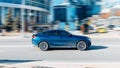 Blue BMW X6 G06 xDrive30d M Sport fast speed drive on city road