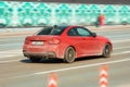 BMW M2 fast moving on the street, rear side view. Car BMW 2 Series Gran Coupe M235i xDrive moving on high speed