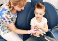 Moscow, Russia - 18 March, 2019: Children dentist shows special dental tool to a kid boy in dental chair in stomatologist office