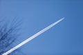 MOSCOW, RUSSIA - MARCH 20, 2018: Condensation tracked by the setting sun behind a twin-engine turbojet passenger plane