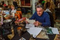 Moscow, Russia - March 19, 2017: An elderly gray-haired man in retirement age is reading document with handwritten text