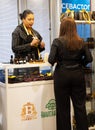 Moscow, Russia - March 29, 2023. A female consultant tells the client about natural essential oils at the exhibition