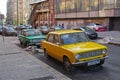 Green and yellow soviet motor cars VAZ 2101 Zhiguli standing on the Arbat in Moscow