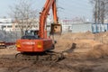 Hitachi excavator on road building site among dirt ground