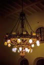 MOSCOW, RUSSIA, March 7, 2013: A large antique round metal chandelier of bronze color hangs on the dark ceiling of Kazan station Royalty Free Stock Photo