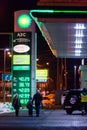 MOSCOW, RUSSIA - MARCH 20, 2018: A man with two children walks past the BP Connect gas station on the highway in a busy Moscow Royalty Free Stock Photo