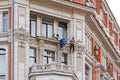 ÃÂ¡onstruction workers reconstructing the facade of Federal Agency of Sea and River transport the former tenement house of Khomyako