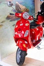 Moscow, Russia - March 30, 2023. Red scooter in stickers from the trip at the exhibition