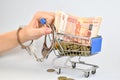 Russian money in a shopping cart. Financial dependency. Credit obligations