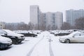 Cars on the parking near the residential house covered by snow Royalty Free Stock Photo