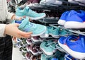 Moscow, Russia, March 2022: Someone chooses childrens or womens blue sneakers in the sports goods store Decathlon