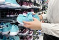 Moscow, Russia, March 2022: Someone chooses childrens or womens blue sneakers in the sports goods store Decathlon