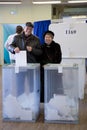 MOSCOW, RUSSIA - MARCH 18, 2018: Voters omit the ballot in an ur