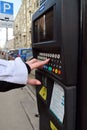 Moscow, Russia - March 14, 2016. Woman's hand enters the data in parking payment machine