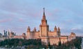 Aerial panoramic view of sunset campus buildings of famous Moscow university under dramatic cloudy sky in spring with sunlight