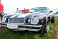 Moscow, Russia - May 25, 2019: Black Chevrolet Camaro Z28 1977 350 with white stripes on the hood and turbo supercharger with red Royalty Free Stock Photo