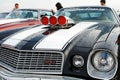 Moscow, Russia - May 25, 2019: Black Chevrolet Camaro Z28 1977 350 with white stripes on the hood and turbo supercharger with red Royalty Free Stock Photo