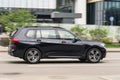 Black color BMW X7 in fast motion on the street