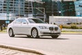 BMW 740Li F02 on the road in motion. Fast speed drive on city road at sunny morning