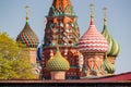 Moscow, Russia - May 01, 2019: Bright colored decorated domes of Saint Basil Cathedral on Red square against blue sky and green Royalty Free Stock Photo