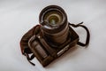 Moscow, Russia - May 13, 2019: Broken reflex dslr digital camera Canon, with a damaged lens 18-135mm on a gray background. The