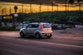 Sunset Highway and Kia Soul car driving in evening. countryside road against beautiful sun down light. Glowing break lights Royalty Free Stock Photo