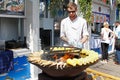 Chef cooks fish and corn on grill at the Fish Week festival in Moscow