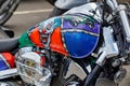 Moscow, Russia - May 04, 2019: Chromed engine and glossy fuel tank with airbrushing of evil clown of Honda motorcycle closeup. Royalty Free Stock Photo