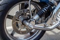 Moscow, Russia - May 04, 2019: Chromed front wheel with disc brake system and shock absorbers of BOOM tourist trike closeup. Moto