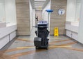 MOSCOW, Russia, May 2021: A cleaning cart with mops in an empty public toilet. On the floor dividing lines for social distance,