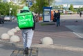 Moscow, Russia-May, 2020: Delivery club courier carrying food delivery green box with company logo walking down the