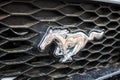 Moscow, Russia - May 25, 2019: Dirty grille with a chrome horse logo. Mustang Royalty Free Stock Photo