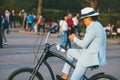 Moscow, Russia - may 1, 2018. Fashionable businessman in a hat, light jacket on a Bicycle, looking at the phone, against