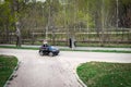 MOSCOW, RUSSIA - MAY 1, 2019: Funny boy car driver with the steering wheel. year-old boy in a white shirt in a red toy Royalty Free Stock Photo