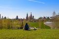 MOSCOW, RUSSIA - MAY 03, 2018: A girl lies in a spring meadow with a view of the Kremlin towers from Zaryadye park Royalty Free Stock Photo