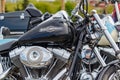 Moscow, Russia - May 04, 2019: Glossy black fuel tank with Harley Davidson motorcycles emblem and chromed engine closeup. Moto