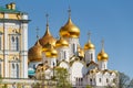 Moscow, Russia - May 01, 2019: Golden domes of Cathedral of the Annunciation of Moscow Kremlin in sunlight against blue sky at Royalty Free Stock Photo