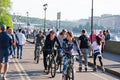 Gorky Central Park of Culture and Leisure full of locals, people ride bicycles on embankment along Moskva River.