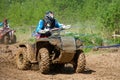 An athlete on an ATV rides through mud Royalty Free Stock Photo