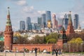 Moscow, Russia - May, 05, 2021: Kremlin Towers and Skyscrapers of Moscow City in spring. The contrast of Moscow architecture with