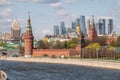 Moscow, Russia - May, 05, 2021: Kremlin Towers and Skyscrapers of Moscow City in spring. The contrast of Moscow architecture with