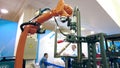 MOSCOW, RUSSIA - MAY 26, 2021. KUKA Robotics robot arm with welding equipment imitates welding of steel pieces at the