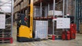 Moscow, Russia - May, 2017: Lift truck in factory. Clip. Wholesale logistic, loading, shipment and people concept - man