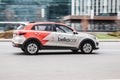 Moscow carsharing Belka Car. Kia Rio hatchback driving along the street on high speed. Car rental concept