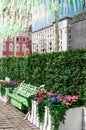 Moscow, Russia - May, 05, 19. Music bench, beautiful flowers and pink,green, white ribbons fluttering in the wind on