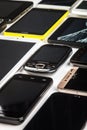 Background of dirty, broken and old smartphones