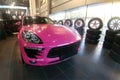 Moscow, Russia - May 09, 2019: Pink Porsche Macan in showroom of dealer center. Car is wrapped in colored protective film. Fisheye