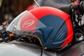 Moscow, Russia - May 04, 2019: Red and black motorcycle helmet Suomy with opened visor lies on a silvery fuel tank of motorcycle Royalty Free Stock Photo