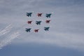 Aerobatic teams `Strizhi` and `Russian Knights` on the planes `Su-30 SM` and `MiG-29` produce a salute in the sky.